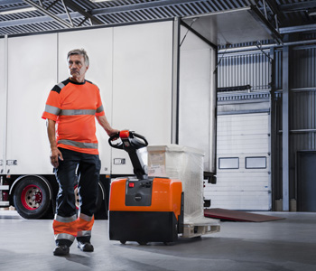 Toyota pedestrian pallet truck unloading lorry