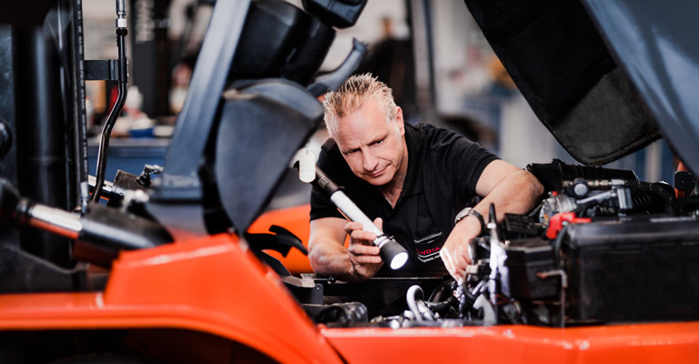 Service technician servicing a Toyota truck